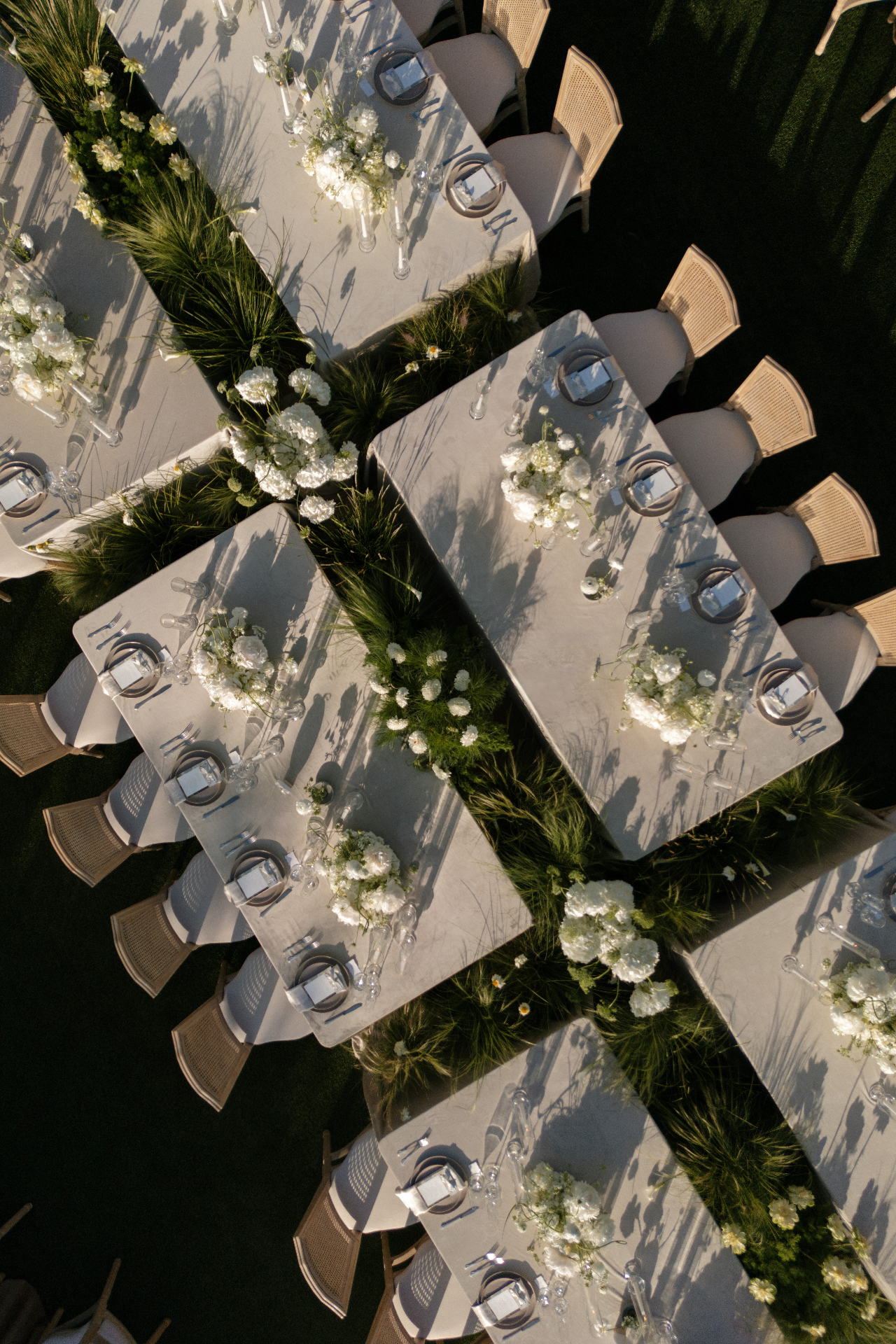 Aerial view of elegant reception tables with white florals and greenery